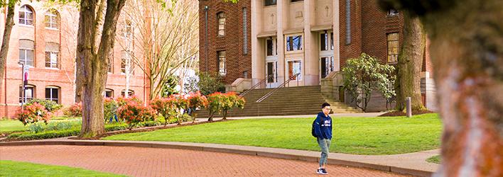 Banner image for degree programs, student walking on campus